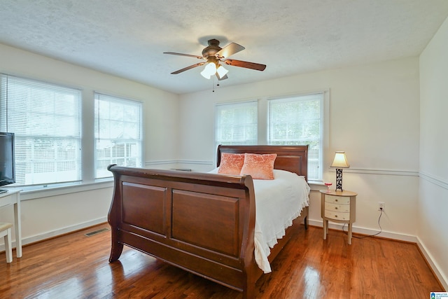 1693 4th Ave N, Clanton, AL 35045 - bedroom with wood finished floors, baseboards, a ceiling fan, and a textured ceiling