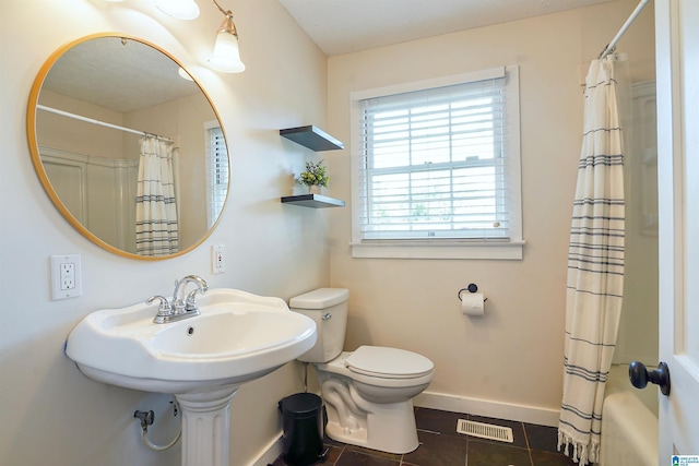 1693 4th Ave N, Clanton, AL 35045 - bathroom with baseboards, toilet, tile patterned flooring, and shower / bath combo