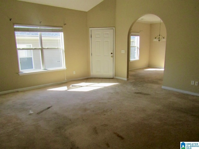 221 High Ridge Dr, Pelham, AL 35124 - unfurnished room with arched walkways, carpet flooring, vaulted ceiling, and baseboards