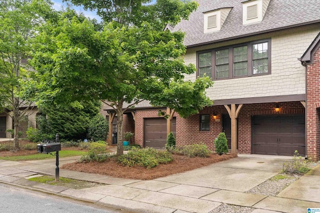 1033 Inverness Cove Way, Hoover, AL 35242 - view of front of house with driveway, brick siding, an attached garage, and a shingled roof