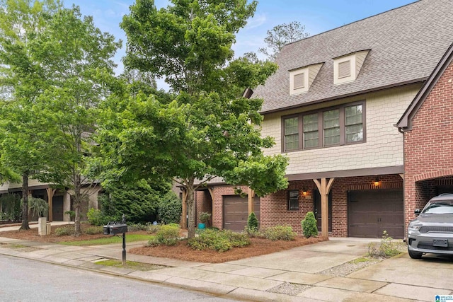 1033 Inverness Cove Way, Hoover, AL 35242 - view of front of property with driveway, roof with shingles, a garage, and brick siding