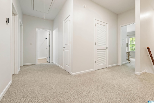 1033 Inverness Cove Way, Hoover, AL 35242 - hallway with attic access, carpet flooring, an upstairs landing, and baseboards