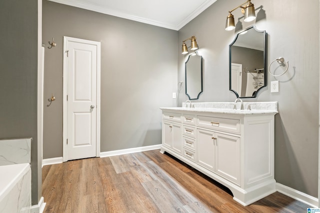 1033 Inverness Cove Way, Hoover, AL 35242 - bathroom featuring wood finished floors, double vanity, ornamental molding, and baseboards