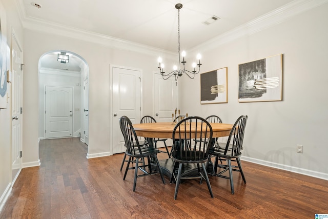 1033 Inverness Cove Way, Hoover, AL 35242 - dining room with arched walkways, a chandelier, dark wood finished floors, ornamental molding, and baseboards