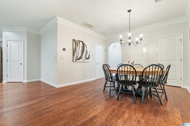 1033 Inverness Cove Way, Hoover, AL 35242 - dining area featuring a chandelier, dark wood-style flooring, ornamental molding, baseboards, and arched walkways