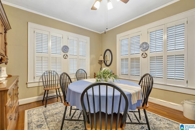 102 E Crest Rd, Hueytown, AL 35023 - dining room with wood finished floors, a ceiling fan, baseboards, crown molding, and plenty of natural light