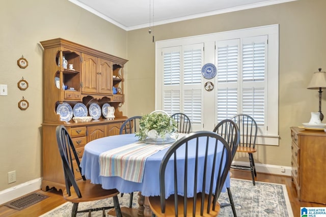 102 E Crest Rd, Hueytown, AL 35023 - dining space with baseboards, light wood-type flooring, and crown molding