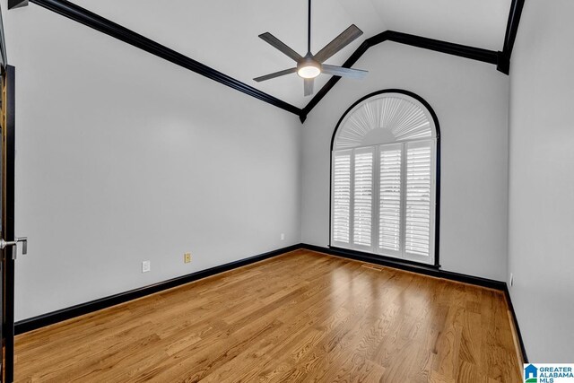 1700 Leisure Ln NW, Cullman, AL 35055 - empty room featuring a ceiling fan, crown molding, lofted ceiling, wood finished floors, and baseboards