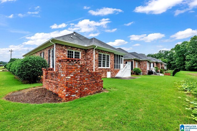 1700 Leisure Ln NW, Cullman, AL 35055 - back of house featuring brick siding, a lawn, and roof with shingles