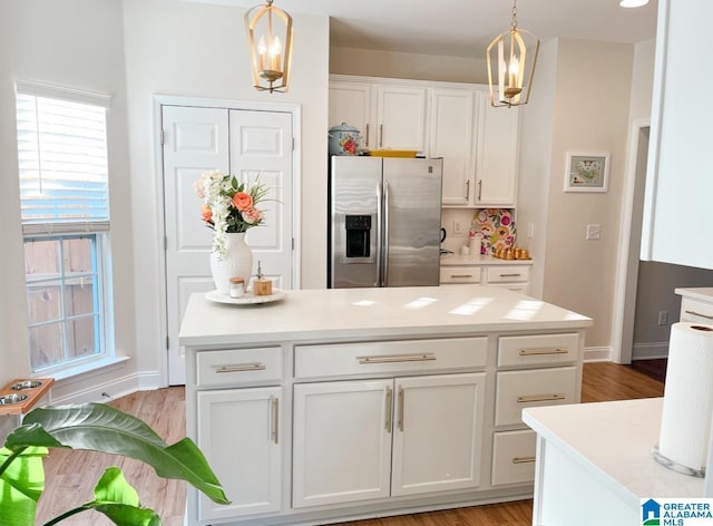 2014 Madison Cir, Chelsea, AL 35043 - kitchen with stainless steel fridge, white cabinets, light wood-style floors, light countertops, and pendant lighting