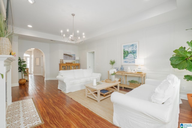 2014 Madison Cir, Chelsea, AL 35043 - living area featuring arched walkways, a raised ceiling, a chandelier, wood finished floors, and recessed lighting