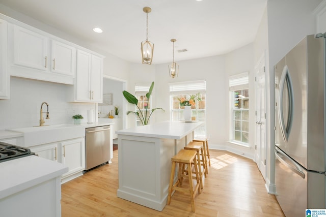 2014 Madison Cir, Chelsea, AL 35043 - kitchen featuring stainless steel appliances, light wood-style flooring, backsplash, light countertops, and recessed lighting