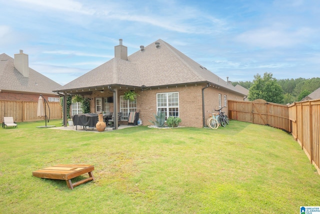 2014 Madison Cir, Chelsea, AL 35043 - back of house featuring brick siding, a patio area, roof with shingles, and a chimney