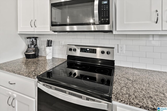 27281 Mckenna Dr, Athens, AL 35613 - kitchen featuring appliances with stainless steel finishes, tasteful backsplash, white cabinetry, and dark stone counters