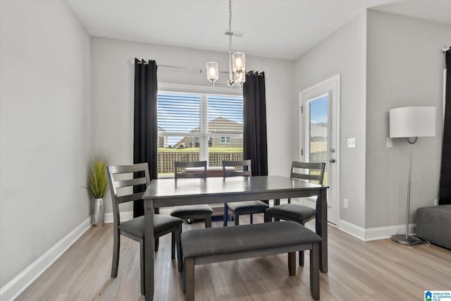 27281 Mckenna Dr, Athens, AL 35613 - dining room with light wood-type flooring, a chandelier, and baseboards