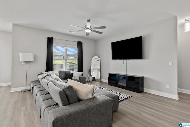 27281 Mckenna Dr, Athens, AL 35613 - living area with a ceiling fan, light wood-type flooring, baseboards, and arched walkways