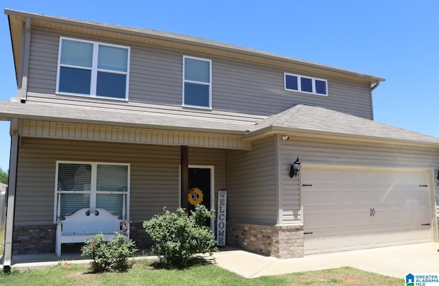 690 Deerwood Dr, Pell City, AL 35125 - view of front facade featuring covered porch, brick siding, and driveway