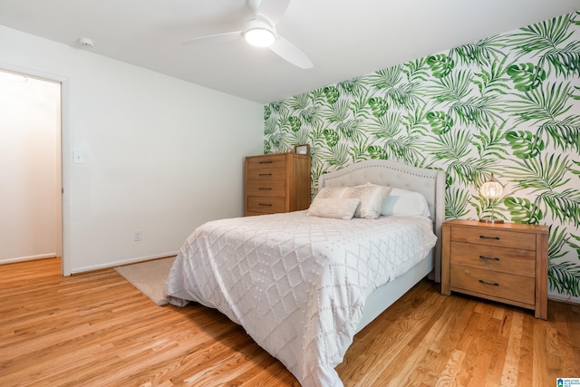 1355 Starcross Dr, Vestavia Hills, AL 35216 - bedroom with wallpapered walls, an accent wall, light wood-style floors, baseboards, and a ceiling fan