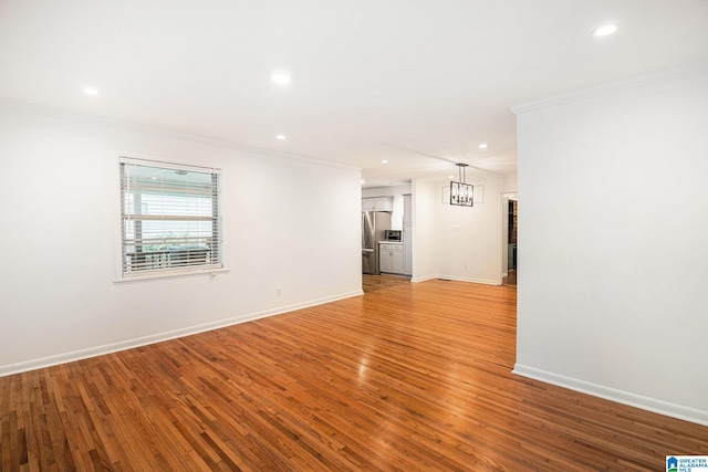 2970 Lake Park Cir, Birmingham, AL 35242 - empty room with crown molding, recessed lighting, baseboards, light wood-type flooring, and a chandelier