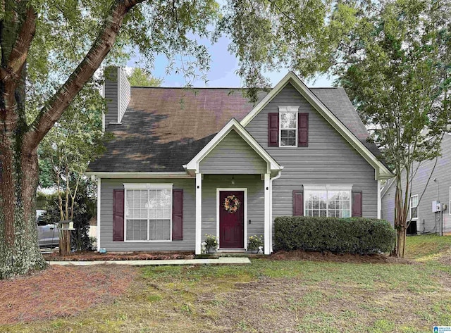 246 Park Place Way, Alabaster, AL 35007 - view of front of home with a chimney, a front yard, a shingled roof, and central AC unit