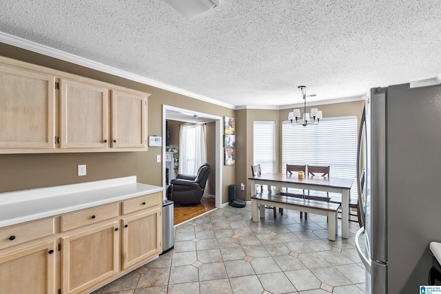 246 Park Place Way, Alabaster, AL 35007 - kitchen with light brown cabinetry, freestanding refrigerator, a textured ceiling, ornamental molding, and a chandelier