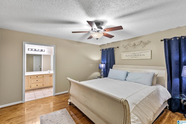 246 Park Place Way, Alabaster, AL 35007 - bedroom with wood finished floors, baseboards, ensuite bath, a ceiling fan, and a textured ceiling