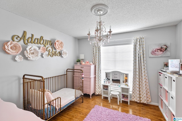 246 Park Place Way, Alabaster, AL 35007 - bedroom with a chandelier, wood finished floors, and a textured ceiling