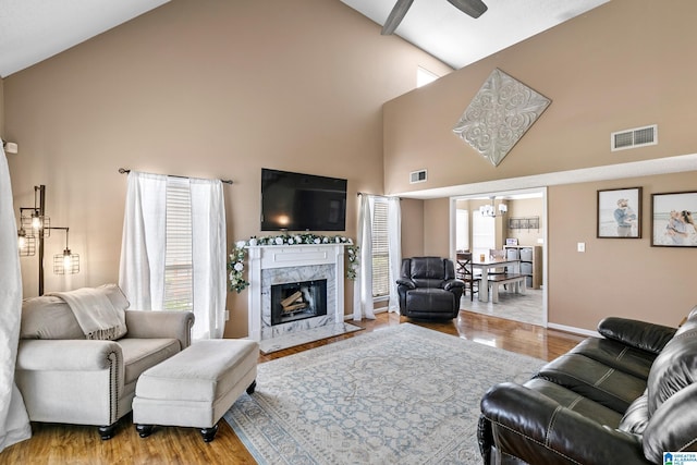 246 Park Place Way, Alabaster, AL 35007 - living area featuring a ceiling fan, high vaulted ceiling, a premium fireplace, wood finished floors, and baseboards