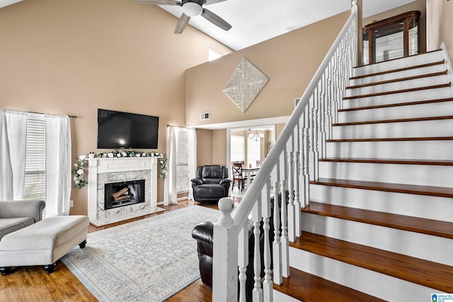 246 Park Place Way, Alabaster, AL 35007 - living area with ceiling fan, high vaulted ceiling, stairs, wood finished floors, and a high end fireplace