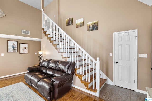 246 Park Place Way, Alabaster, AL 35007 - staircase featuring a towering ceiling, baseboards, and wood finished floors