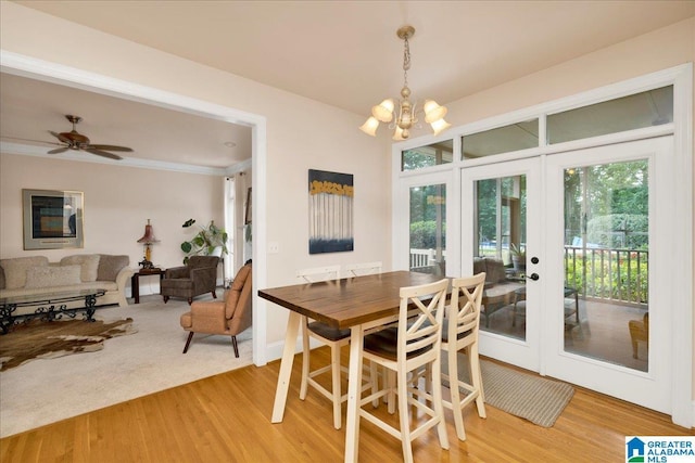 1222 Eagle Park Rd, Birmingham, AL 35242 - dining space featuring french doors, light wood-type flooring, a chandelier, ornamental molding, and ceiling fan