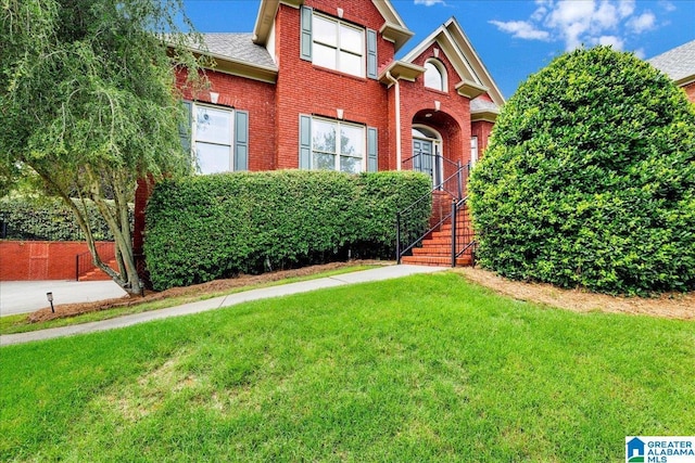 1222 Eagle Park Rd, Birmingham, AL 35242 - traditional-style house featuring a front yard, brick siding, roof with shingles, and stairway