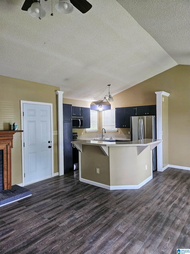 5967 Honeysuckle Cir, Pinson, AL 35126 - kitchen with stainless steel appliances, dark wood-style flooring, light countertops, a sink, and a textured ceiling