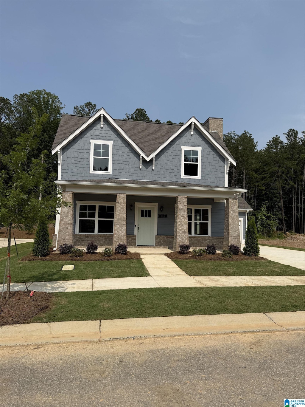 205 Barimore Blvd, Helena, AL 35080 - craftsman-style home featuring a chimney, a front lawn, brick siding, a porch, and driveway