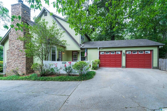 3504 William And Mary Rd, Hoover, AL 35216 - view of front of house with driveway, a garage, roof with shingles, and a chimney