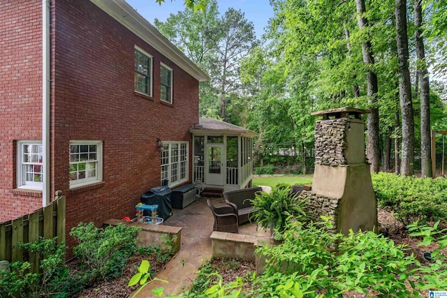 208 Maple Trce, Hoover, AL 35244 - rear view of house featuring a sunroom, a patio, brick siding, and an outdoor hangout area