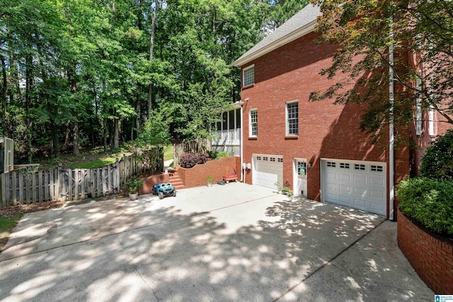 208 Maple Trce, Hoover, AL 35244 - view of side of home with driveway, a garage, and brick siding