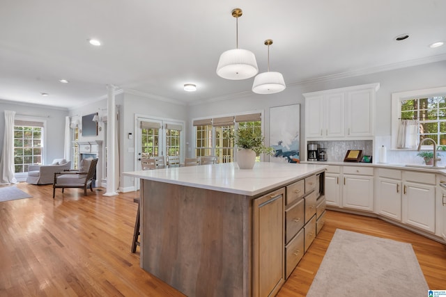 208 Maple Trce, Hoover, AL 35244 - kitchen with white cabinetry, a center island, light wood finished floors, decorative backsplash, and open floor plan