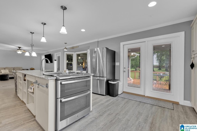 2028 Moncrief Rd, Gardendale, AL 35071 - kitchen featuring stainless steel appliances, open floor plan, a center island with sink, ornamental molding, and light wood-type flooring