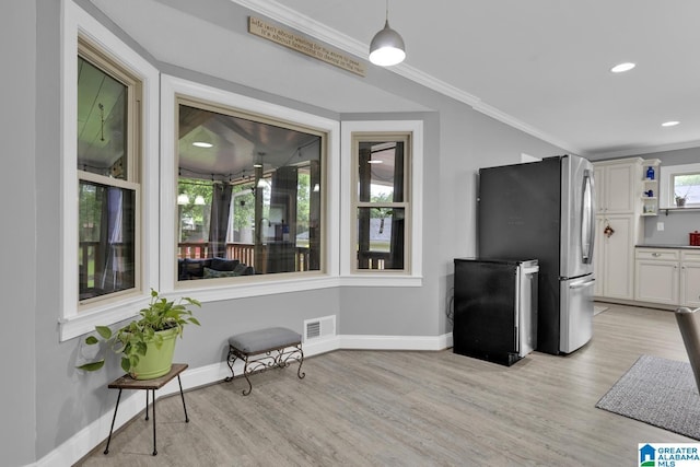 2028 Moncrief Rd, Gardendale, AL 35071 - kitchen with freestanding refrigerator, ornamental molding, light wood finished floors, open shelves, and baseboards