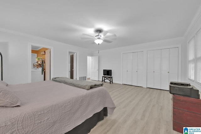 2028 Moncrief Rd, Gardendale, AL 35071 - bedroom with multiple closets, wood finished floors, ornamental molding, and ceiling fan