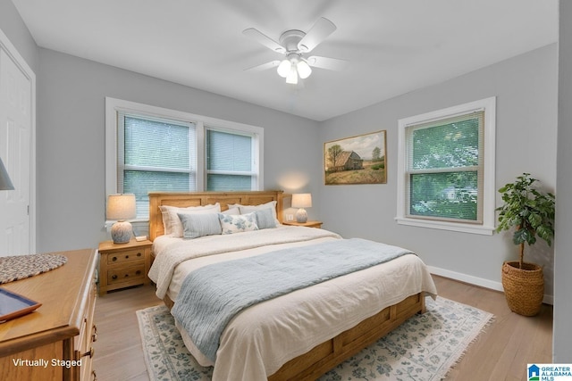 2028 Moncrief Rd, Gardendale, AL 35071 - bedroom featuring multiple windows, light wood-style floors, ceiling fan, and baseboards