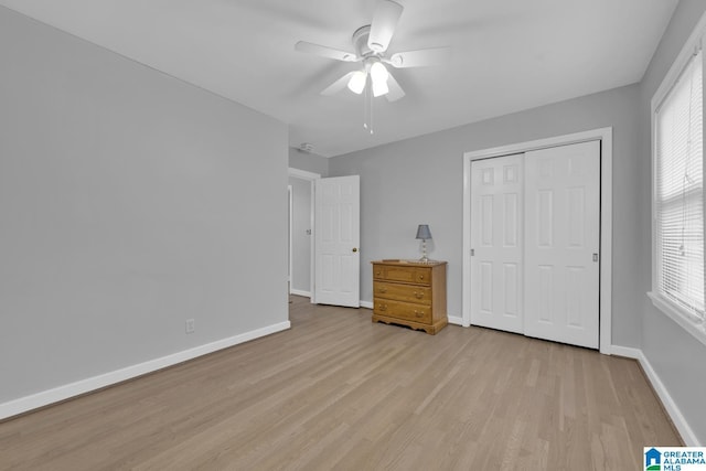 2028 Moncrief Rd, Gardendale, AL 35071 - unfurnished bedroom featuring light wood-style flooring, baseboards, a closet, and multiple windows