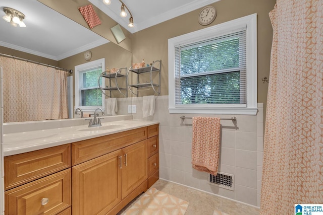 2028 Moncrief Rd, Gardendale, AL 35071 - full bathroom featuring crown molding, vanity, tile patterned floors, tile walls, and wainscoting