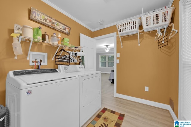 2028 Moncrief Rd, Gardendale, AL 35071 - washroom with washer and dryer, light wood finished floors, baseboards, and crown molding