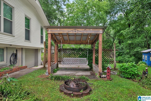 2028 Moncrief Rd, Gardendale, AL 35071 - view of yard featuring an attached garage and an outdoor fire pit