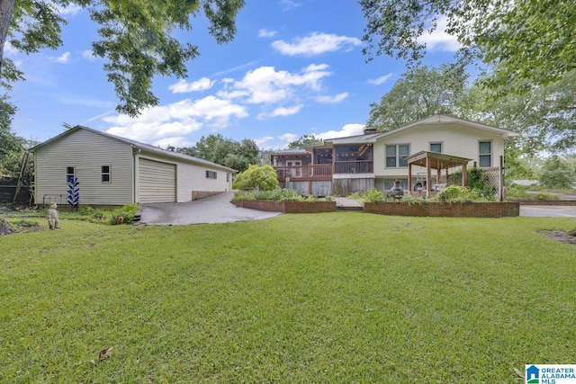 2028 Moncrief Rd, Gardendale, AL 35071 - view of grassy yard with a detached garage, an outbuilding, a patio area, and a sunroom