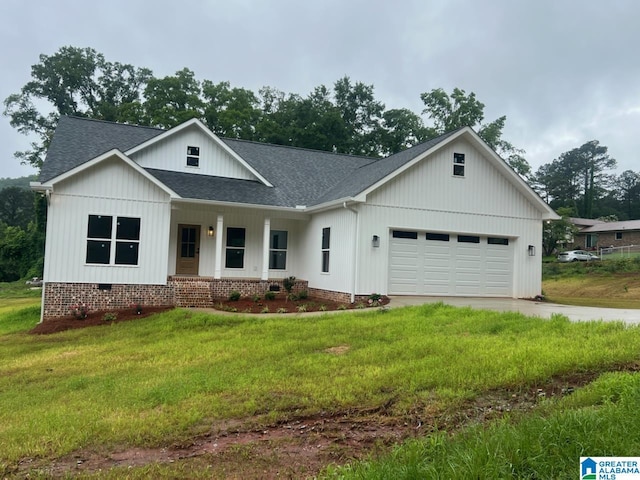 610 Adamson St, Piedmont, AL 36272 - modern inspired farmhouse featuring roof with shingles, a porch, a garage, concrete driveway, and a front lawn