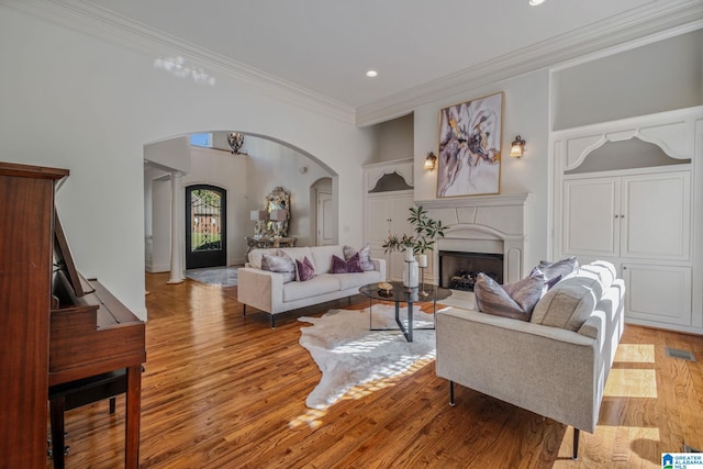 386 N Lake Rd, Birmingham, AL 35242 - living area featuring arched walkways, ornamental molding, light wood-style floors, recessed lighting, and a fireplace