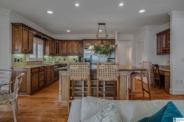 386 N Lake Rd, Birmingham, AL 35242 - kitchen with light wood-type flooring, a kitchen island, glass insert cabinets, a kitchen bar, and recessed lighting